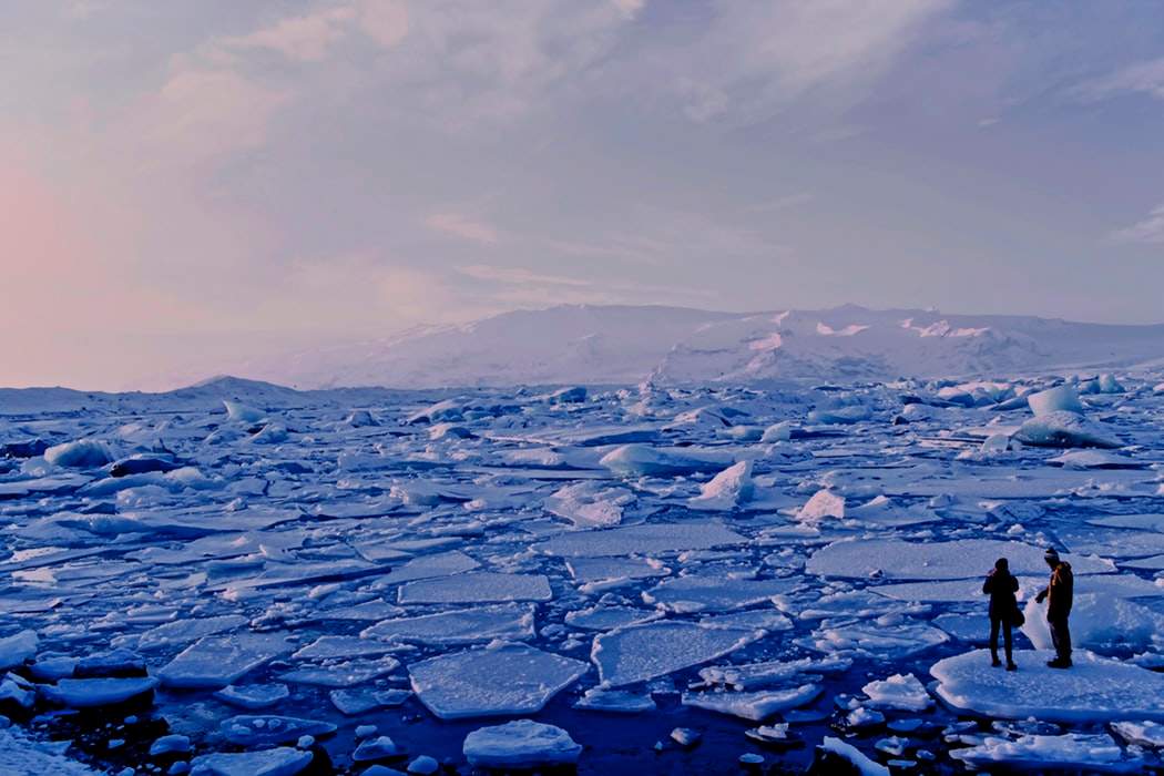 2 people contemplating climate change on melting ice